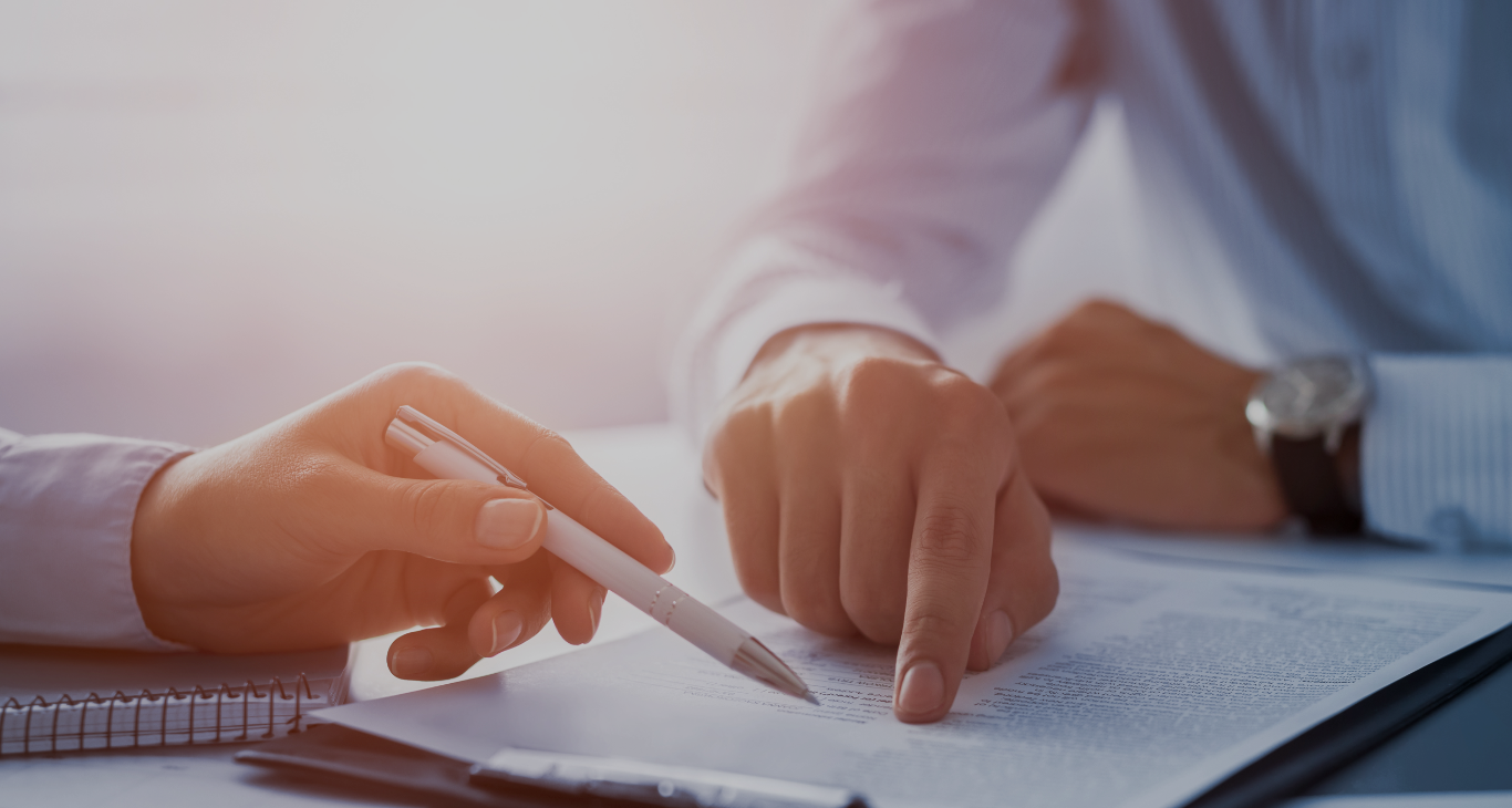 Person pointing at info in book